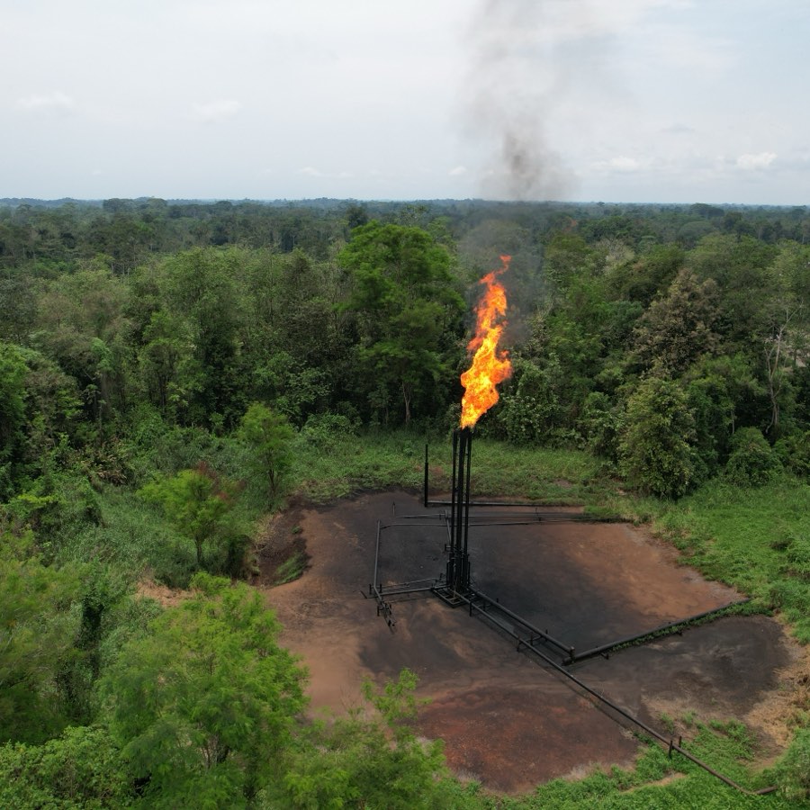 A gas flare burning at a wellpad cut into Amazonian forest